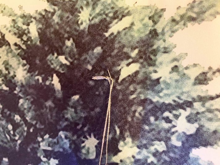 安全ピンを布の裏側から刺してヒモを通して留めるだけ