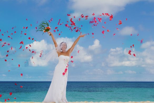 young hapy smiling bride on the wedding day on tropical beach and sea background