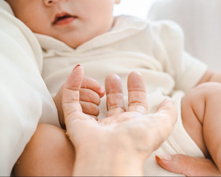 赤ちゃんを抱っこしてふれあうシニア女性