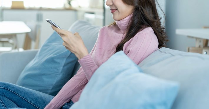 スマホを見て笑う女性