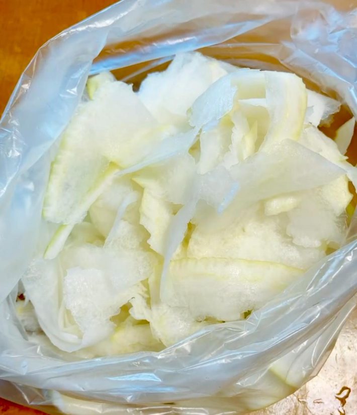 大根をピーラーで薄切りして袋に入れる