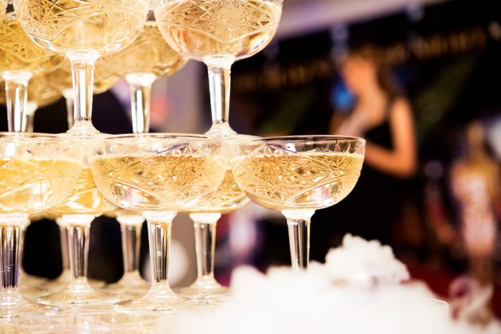 champagne glasses standing in a tower at the party